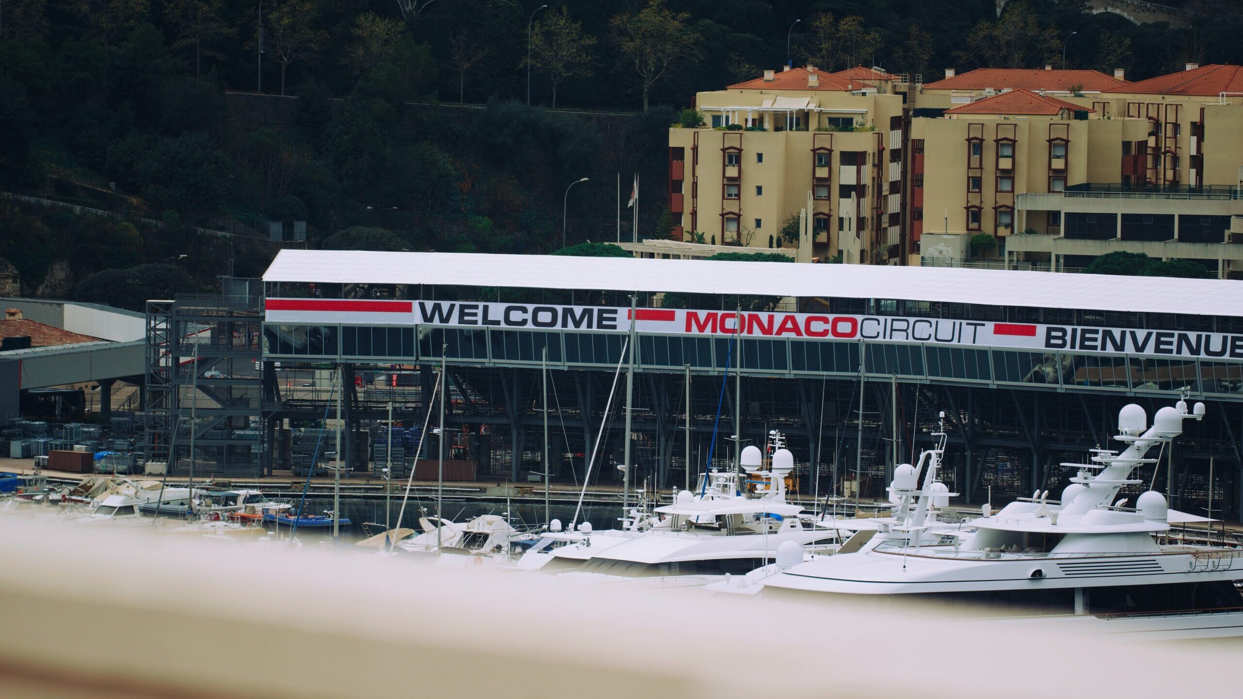 Boats in front of "Welcome Monaco Circuit Bienvenue" sign
