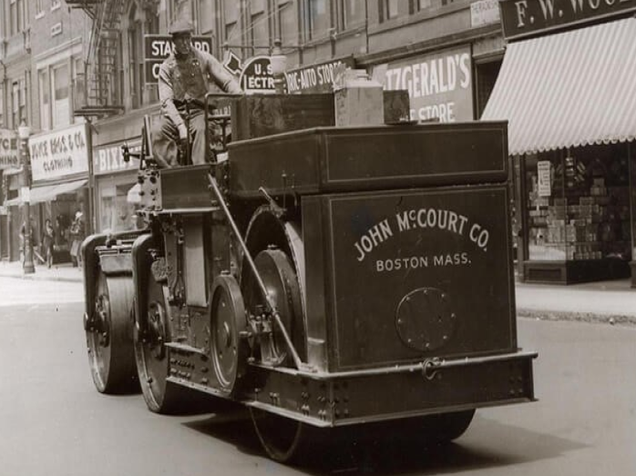 black-and-white; John McCourt Co. roller truck on a Boston street in the early 20th century