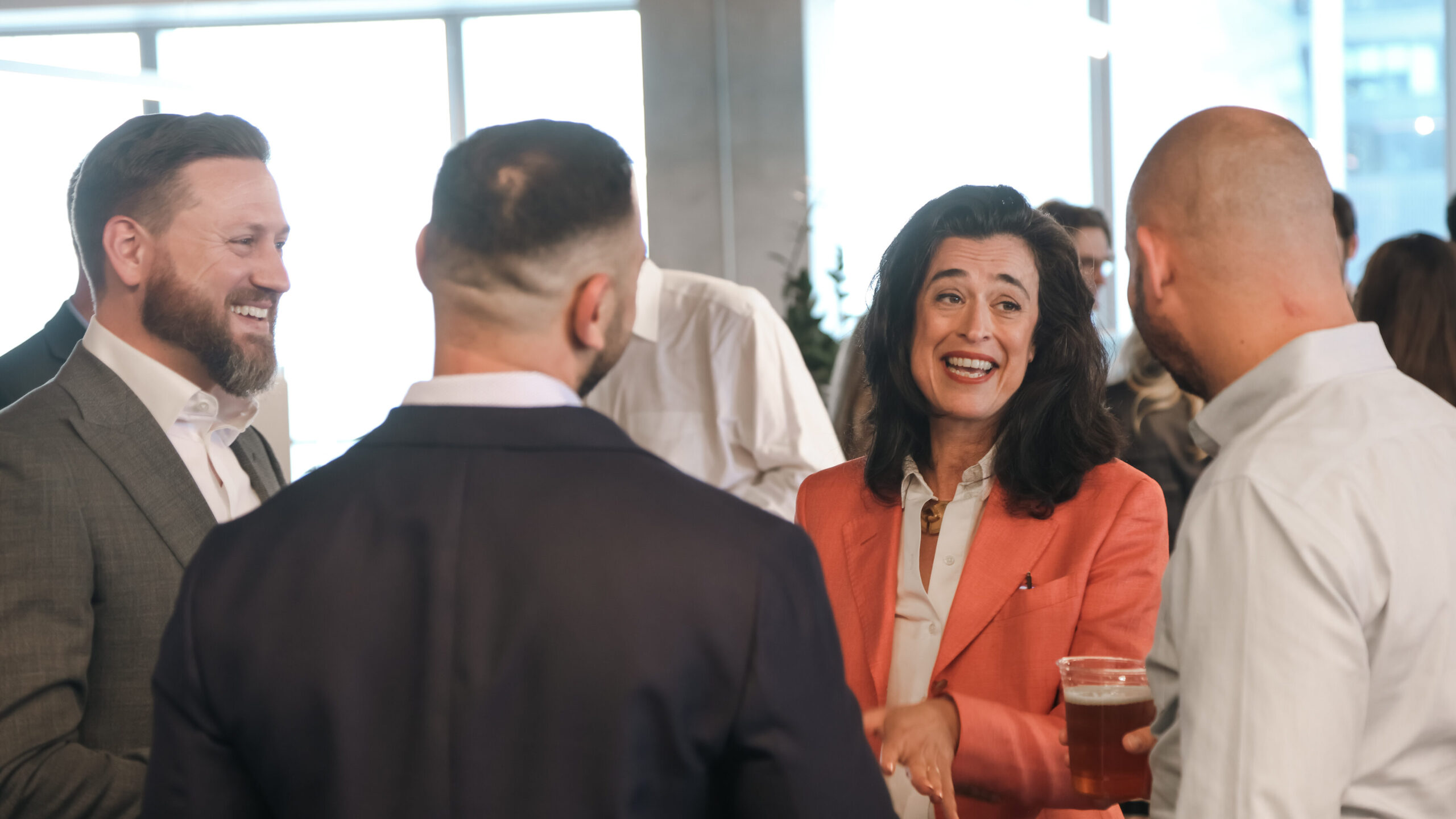 Group of McCourt Global employees socializing in the NYC office