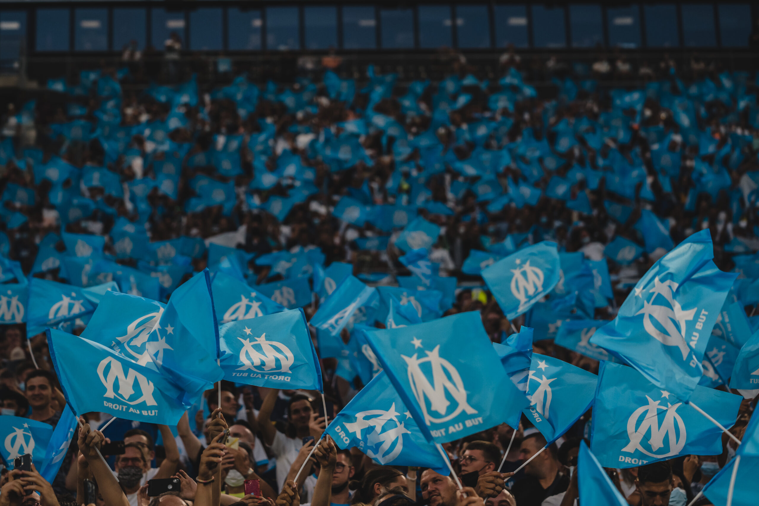 Fans in the stands waiving Olympique de Marseille flags
