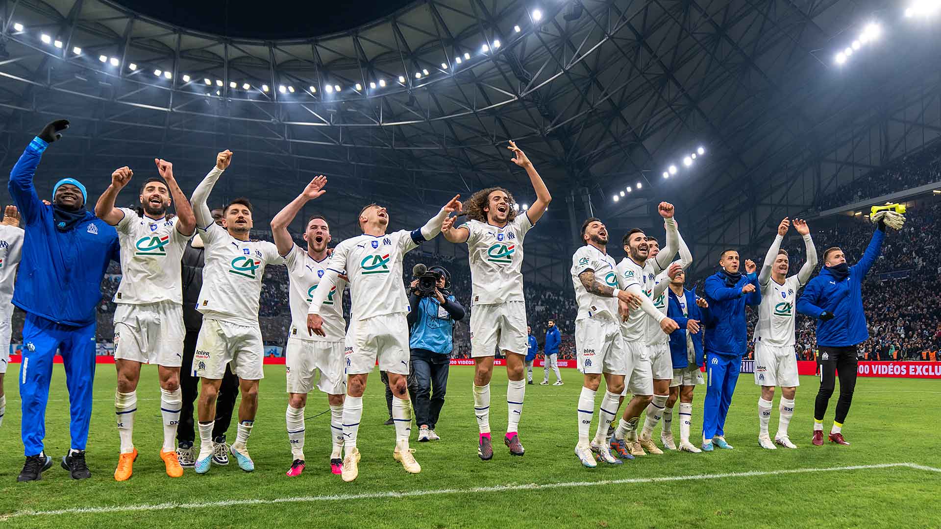 OM players and staff celebrating after a win at the Orange Vélodrome