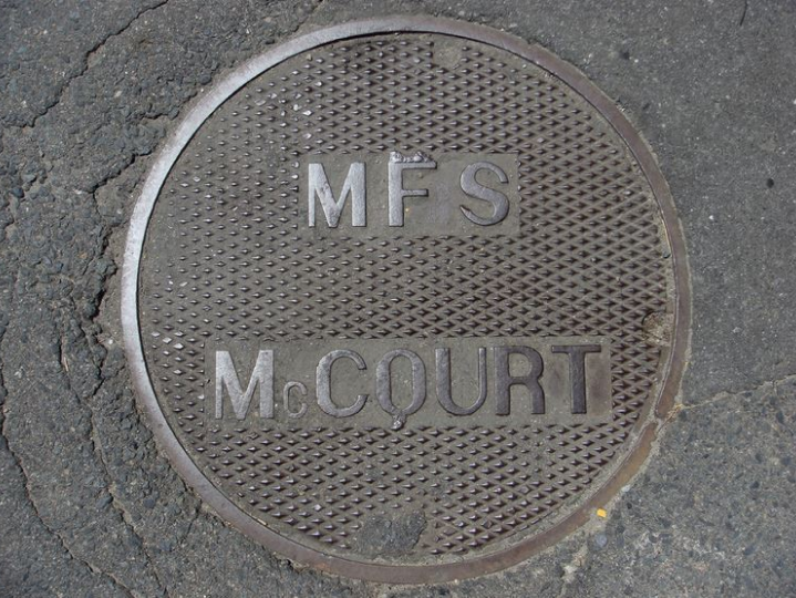 Manhole cover with "MFS McCourt" on it