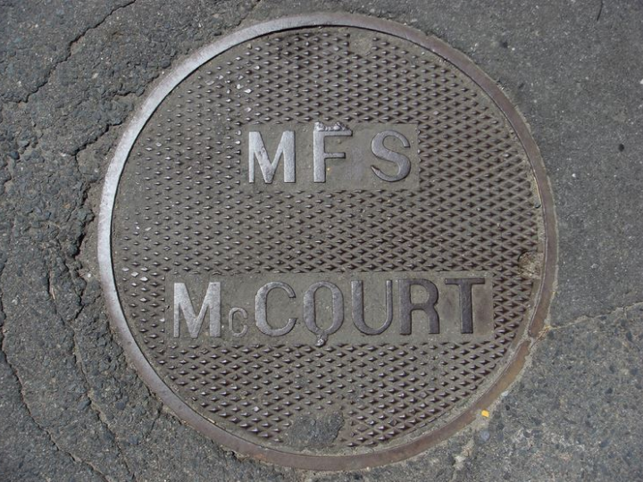 Manhole cover with "MFS McCourt" on it