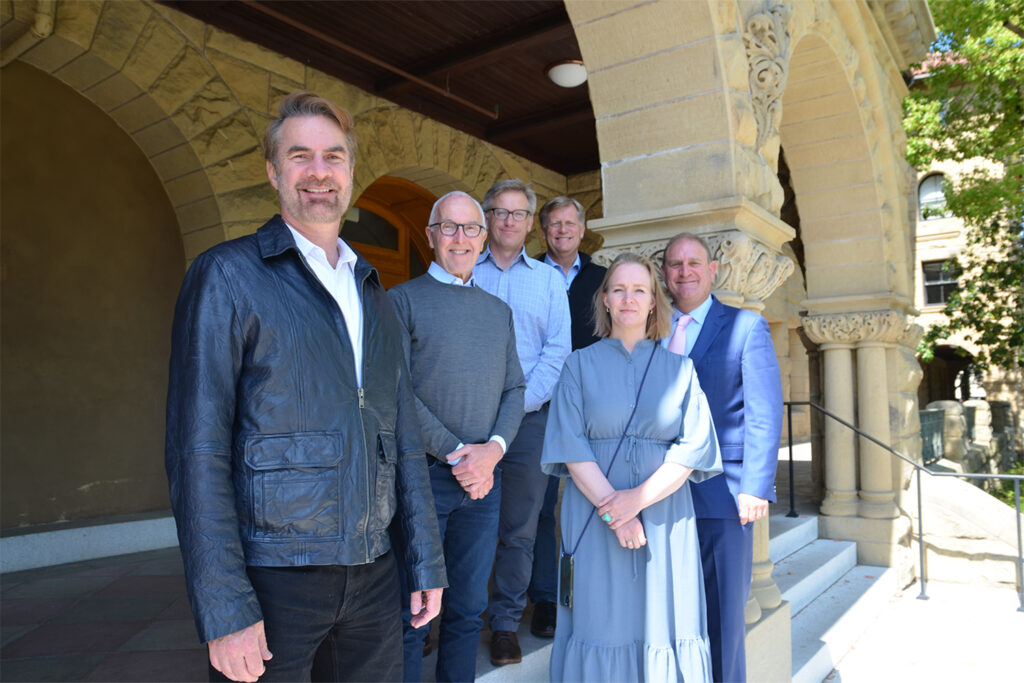 Group standing in front of a sandstone building