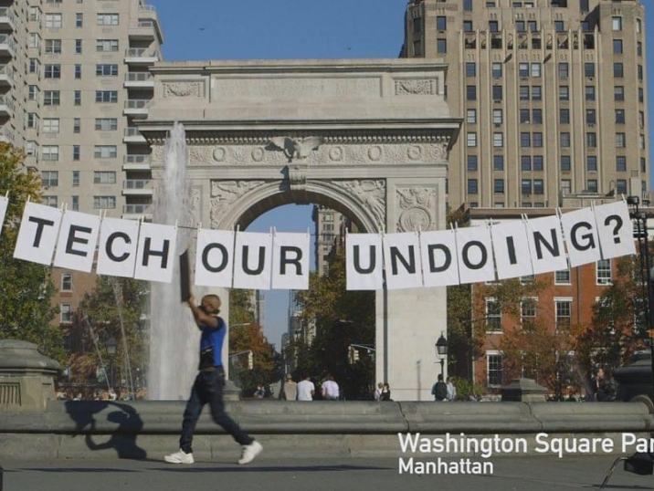 Unfinished demonstration in Washington Square Park; a banner with "TECH OUR UNDOING?" text
