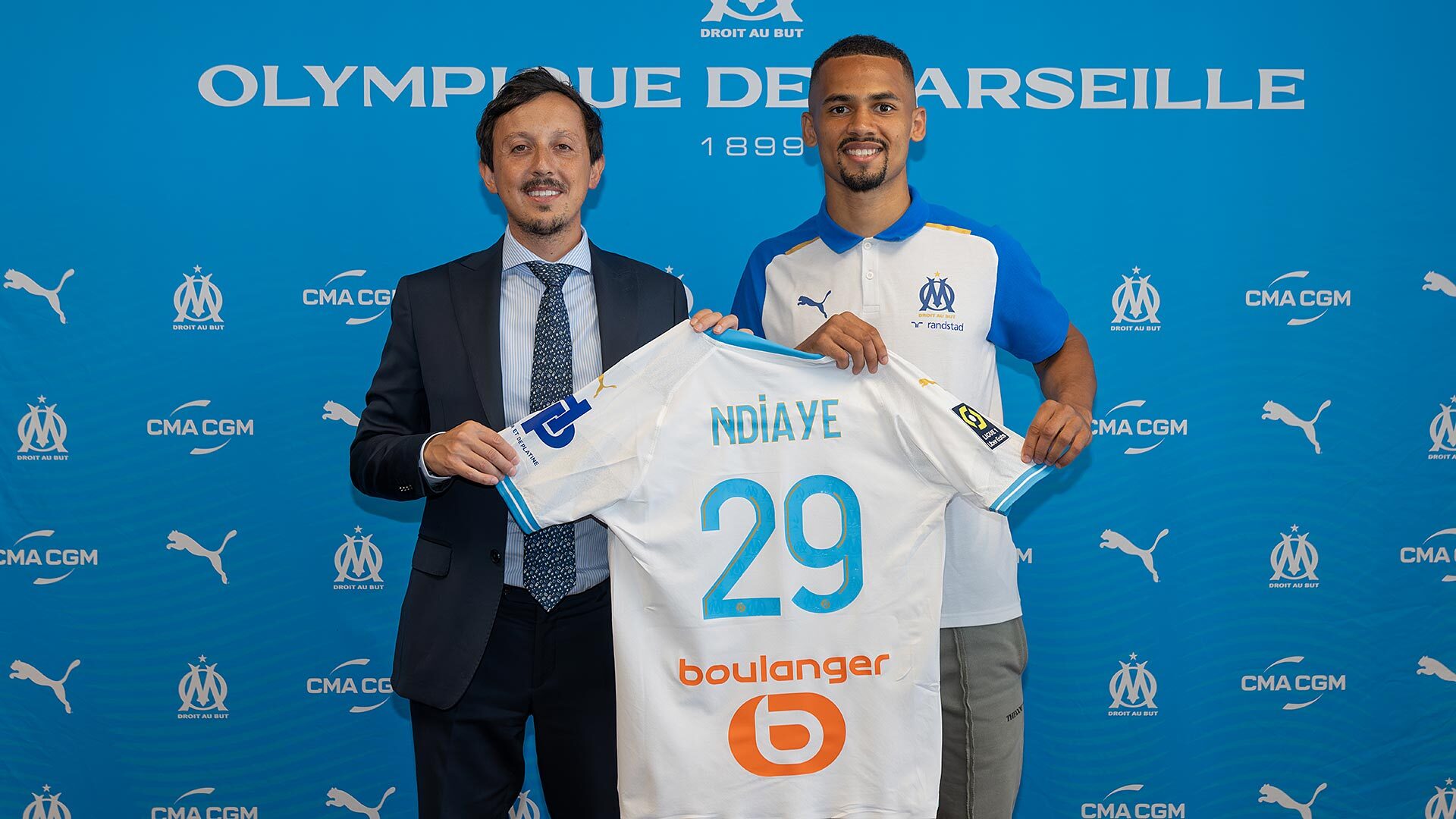 Pablo Longoria with OM player Iliman Ndiaye and his jersey
